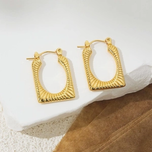 Macro detail of 18K gold-plated stainless steel earrings with radiant pleated texture