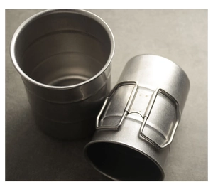 Detail view of two stackable camping cups with foldable handles in 304 stainless steel