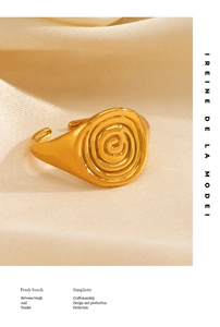 Close-up of golden spiral ring on silk background with 18K gold plated texture