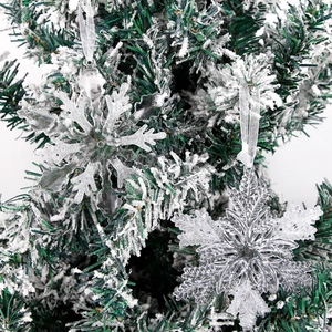 Macro view of transparent acrylic snowflake ornaments with silver glitter on Christmas tree