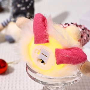 Close-up of the battery compartment and toggle switch on pink sequin gnome plush decor