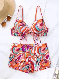 Flat lay of floral print bikini set with underwire top and high waist boy shorts on marble