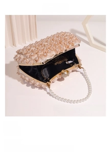 Detail view of cream evening bag interior with gold chain and pearl strap
