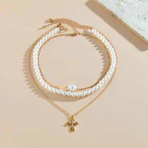 Detail of multi-layer beaded necklace set with starfish, pearls and cross pendant
