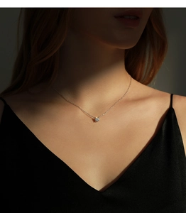 Elegant 80-carat moissanite necklace in S925 silver worn on a model in dramatic lighting