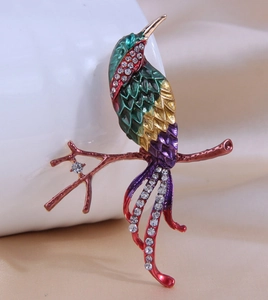 Detailed close-up of colorful enamel magpie bird brooch with sparkling crystal accents
