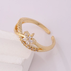 Macro detail of 18K gold-plated open ring with zircon flower and double band design
