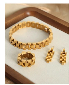 Flat lay of gold-plated titanium steel jewelry set featuring unique watchband chain design