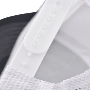 Detail of adjustable white snapback closure and mesh fabric on the black baseball cap