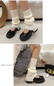 Detail of cream rib-knit leg warmers styled with black Mary Jane shoes for JK style