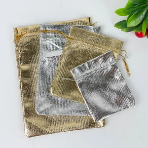 Metallic gold and silver drawstring gift bags in four sizes on a white background