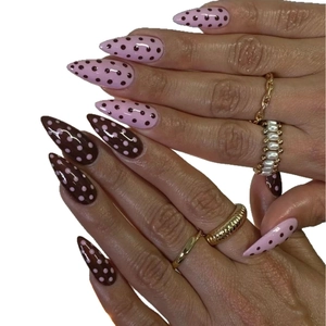 Pink and chocolate polka dot stiletto press-on nails with a glossy mirror finish