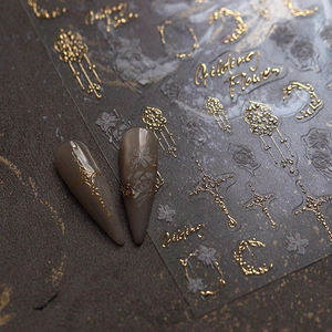 Embossed gold nail stickers with vintage cross and baroque floral motifs on nails