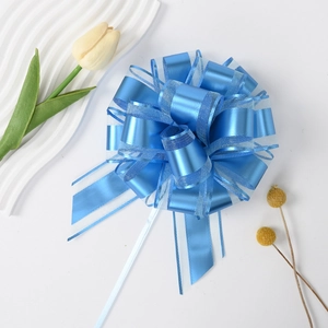 Detail of blue matte organza pull bow for gift boxes and wedding decoration