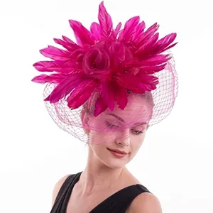 Detail of rose red feather flower headpiece with mesh veil worn by a model