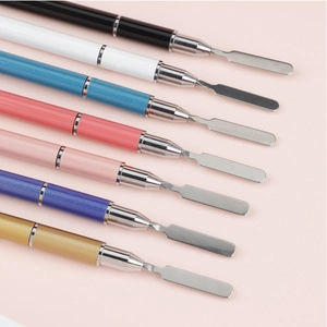 Macro detail of seven colorful dual-ended nail art spatulas with stainless steel tips