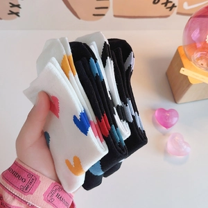 Fashionable mid-calf heart pattern cotton socks in black and white colors for women