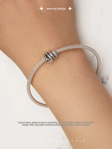 Close-up of S925 sterling silver woven mesh bracelet with vintage knot detail on wrist