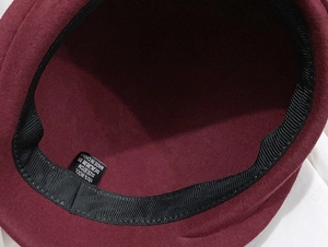 Detail view of 100% wool material and interior sweatband with size 57cm label