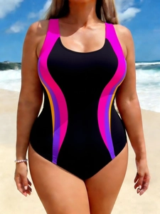 Slimming one-piece swimsuit with colorful side panels and a black base on a sunny beach