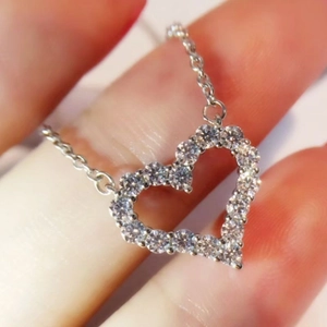 Elegant silver heart necklace with pavé-set sparkling crystals on a delicate chain
