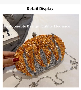 Detail of evening clutch with orange stones, silver glitter finish and rhinestone clasp