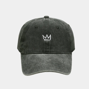 Detailed view of white crown embroidery on vintage washed dark grey denim baseball cap