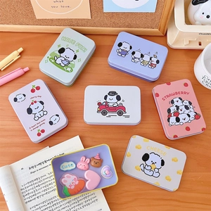 Flat lay of multiple colorful rectangular tin boxes with cute cartoon dog illustrations