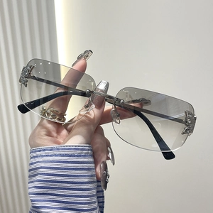 Rimless Y2K butterfly sunglasses with gradient grey lenses and silver rhinestone detail