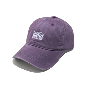 Detail of Hello embroidery on washed purple cotton baseball cap with vintage texture