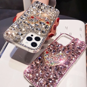 Close-up of sparkling rhinestone phone cases with 3D heart crystal for iPhone series