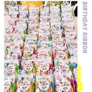 Bulk DIY snack gift bags with white ribbons and birthday tags for children's parties