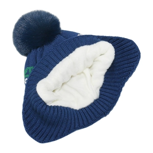 Detail of navy knit hat showing soft white fleece lining and large faux fur pompom