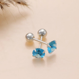 Macro detail of silver magnetic stud earrings featuring round sea blue cubic zirconia