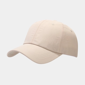 Close-up of beige waterproof baseball cap showing reinforced stitching and breathable eyelets