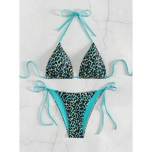 Detail of blue leopard print bikini top and side-tie bottoms on textured surface