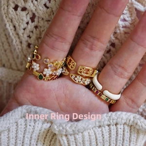 Detail view of the adjustable golden inner band structure for these pearl and zircon rings