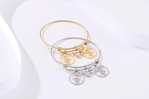 Close-up of adjustable stainless steel bangles with boy, girl, and heart charms