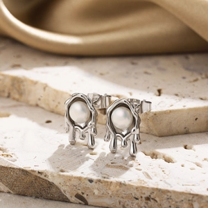 Molten lava style earrings with pearls and silver irregular metal on textured stone