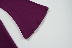 Detail of flared cuffs and neat stitching on purple ribbed knit maxi dress fabric