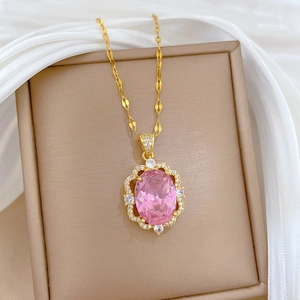 Detail of gold titanium necklace with pink oval gemstone and micro-pave crystals