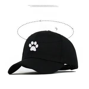 Detail of baseball cap with white cat paw embroidery and precise size specifications