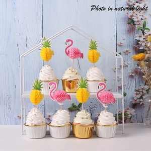 Detail view of 3D honeycomb pineapple and flamingo cupcake toppers for party decor