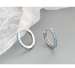 Macro shot of S925 sterling silver hoop earrings with micro-inlaid turquoise stones