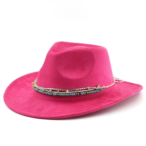 Detailed close-up of hot pink fedora hat with turquoise beads and ethnic style band