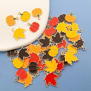 Enamel pumpkin and maple leaf metal charms for DIY jewelry making and Thanksgiving crafts