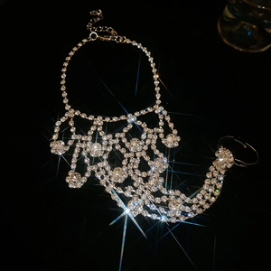 Macro shot of silver ring-bracelet with sparkling crystal tassels and fringe detail