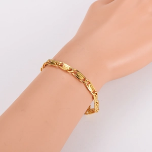 Elegant gold paperclip chain bracelet for women shown on a model hand with white background