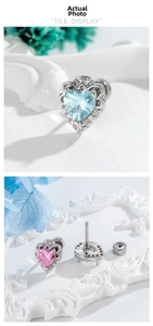 Detailed macro of heart-shaped cartilage studs with blue and pink cubic zirconia