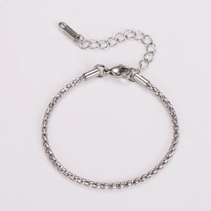 Detailed macro view of a silver stainless steel box chain bracelet with a secure lobster clasp